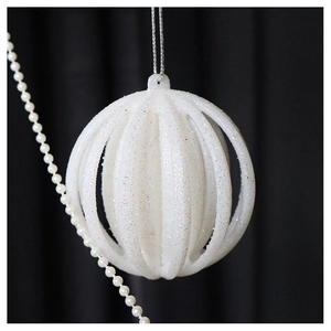 Macro shot of sparkling champagne openwork lantern ball with silver hanging cord