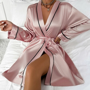 Short pink satin silk robe with black trim and waist tie for a minimalist loungewear look