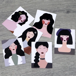 Cartoon goddess jewelry display cards for earrings and necklaces on grey wood surface