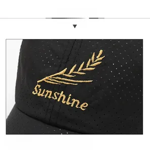 Close-up of golden Sunshine embroidery and breathable black mesh on baseball cap
