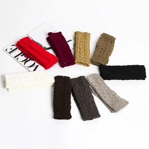 Detailed cable knit pattern on warm acrylic fingerless gloves in various solid colors