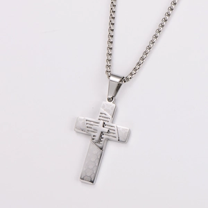 Detailed view of silver stainless steel cross pendant with unique geometric texture