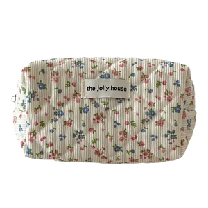 Floral corduroy makeup bag with quilted pattern and pink flower print for storage
