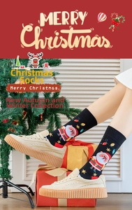 Detail view of cartoon Santa Claus socks worn with sneakers in a festive Christmas setting