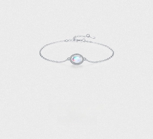 Macro detail of S925 silver bracelet featuring oval moonstone and micro-inlaid crystals
