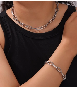 Close-up of hip-hop silver titanium steel necklace set with twisted chain texture