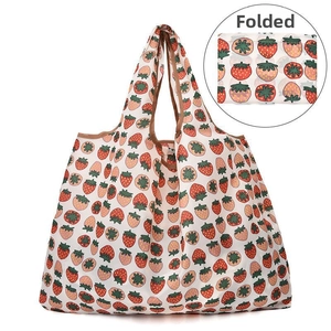 Foldable strawberry print tote bag detail showing large capacity and compact folded form