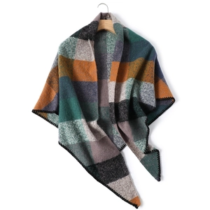 Detail of color block cashmere-like knit scarf featuring black decorative stitching edge