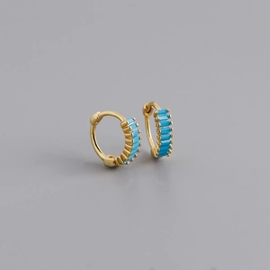 Close-up of gold-plated huggie earrings set with rectangular turquoise stones