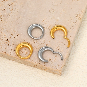 316L stainless steel crescent septum rings in gold and silver on stone display