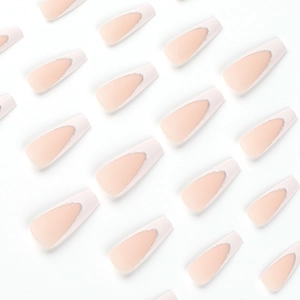 French tip coffin nails in nude pink with white edges and silver glitter details