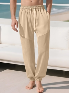 Detail of drawstring waist and spliced textured fabric on casual beige men's trousers