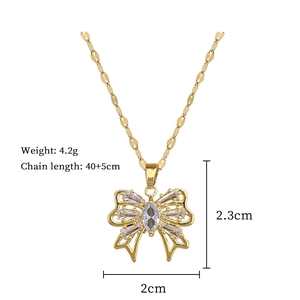 Detailed view of gold bow necklace with crystal pavé and product size specifications