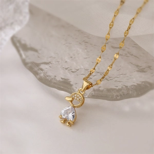 Detailed close-up of heart-shaped zircon boy pendant on a gold micro-pave necklace