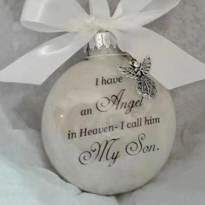 Memorial Christmas ornament featuring white ribbon bow and angel wing charm details