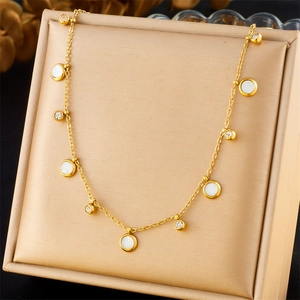 Gold stainless steel necklace featuring round white shells and sparkling zircon pendants
