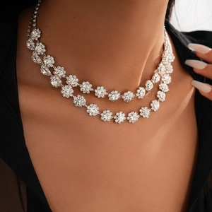 Close-up of a silver double-layer floral necklace with sparkling rhinestones on neck