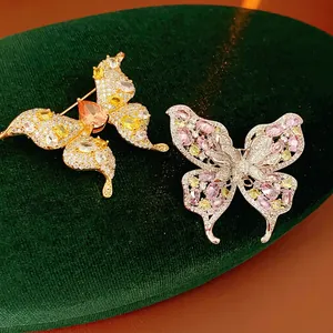 Luxury butterfly brooch with sparkling zircon in gold and silver plating on velvet
