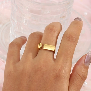 Close-up of a 18K gold plated geometric open ring worn on a finger with pearls