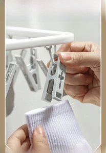 Detail of multi-clip laundry rack with non-slip clips holding socks securely in place