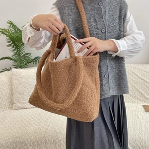 Detailed view of caramel fleece tote bag with soft plush texture and side brand label