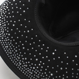 Macro view of black suede fedora hat with sparkling rhinestones on the wide brim