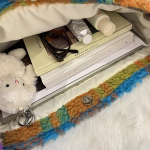 Interior view of colorful plush tote bag showing spacious capacity with books and accessories