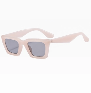 Side view of square thick frame sunglasses in soft nude pink with dark grey lenses