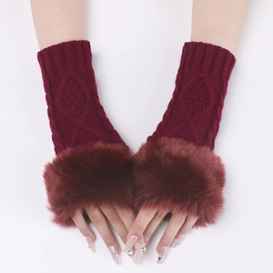 Detail of wine red knit fingerless gloves with plush faux fur trim and diamond pattern