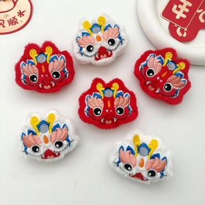 Macro shot of plush dragon embroidery patches in red and white for New Year decor