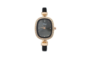 Detail of elegant black oval dial with golden rhinestone case and black leather strap