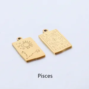 Macro view of gold rectangular Pisces zodiac pendant with engraved sun and moon motifs