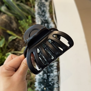 Detail view of large matte black hair claw clip with sturdy resin teeth for thick hair