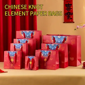 Detailed set of red Chinese gift bags with golden knot patterns in various sizes