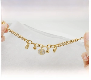 Detail of 18K gold double-layer chain bracelet with handcrafted pavé diamond pendants