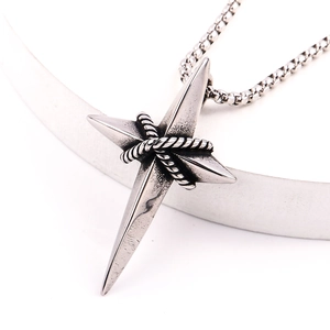 Macro shot of retro silver star cross pendant with rope texture and steel chain link