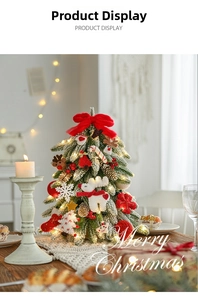 Detail of a mini flocked Christmas tree with LED lights and festive ornaments