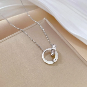 Macro detail of interlocking double rings with square zircon stones and silver chain