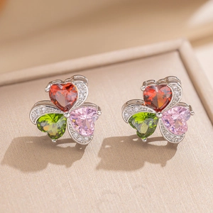 Macro shot of clover earrings with red, pink, and green heart-shaped cubic zirconia
