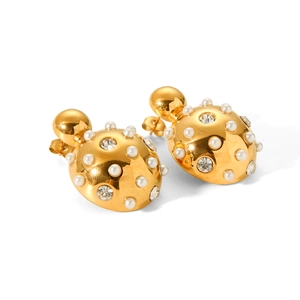 Macro detail of gold ladybug earrings with white pearls and sparkling rhinestones