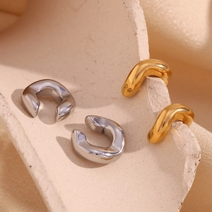 Polished 18K gold and silver plated stainless steel C-shaped thick ear cuffs on silk fabric