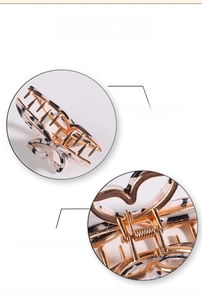 Detail view of butterfly hair claw clip with smooth golden edges and durable spring mechanism