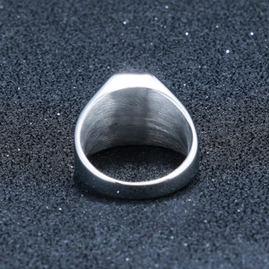 Detailed close-up showing the brushed texture and thick band of the steel signet ring