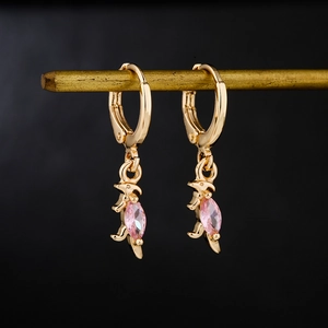 Golden hoop earrings with pink gemstone dinosaur pendant on a professional black background
