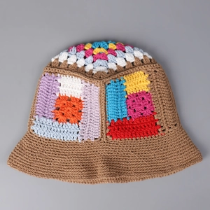 Top-down view of handmade colorful crochet bucket hat with vibrant granny square pattern