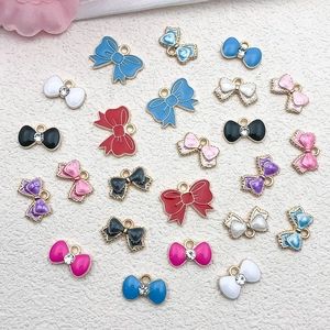 Macro detail of colorful enamel bow charms with rhinestones for DIY jewelry making