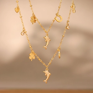 Golden double-layer necklace with dolphin, four-leaf clover, and heart charms