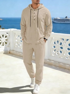 Detail of beige linen men's set featuring a buttoned hoodie and drawstring trousers