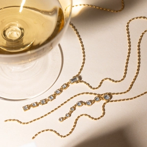 Elegant 18K gold-plated Y-necklace with geometric cubic zirconia stones in warm lighting