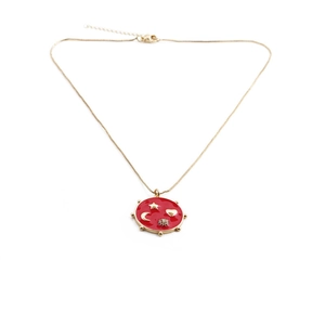 Gold chain necklace with red enamel round pendant featuring star, moon and heart relief